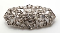 Lot 1002 - A diamond Art Deco brooch, c.1930, the central...