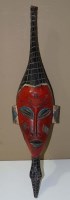 Lot 1105 - A Baule face mask, Ivory Coast, painted red,...