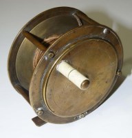 Lot 1112 - A late 19th Century brass fishing reel, by J....