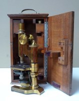 Lot 1133 - A 19th Century lacquered brass microscope, by...