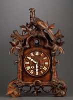 Lot 1260 - A carved cuckoo clock, with roman dial, two...