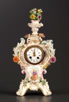 Lot 1296 - A German porcelain mantel clock, the enamelled...