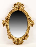 Lot 1307 - An 18th Century giltwood oval mirror, the...