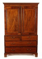 Lot 1325 - A Georgian mahogany linen press with dentil...