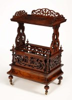 Lot 1337 - A Victorian walnut Canterbury whatnot, the...