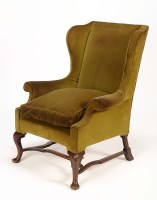 Lot 1341 - A George II style wing chair upholstered in...