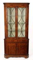 Lot 1351 - A mahogany Georgian style corner cupboard,...