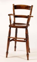 Lot 1370 - A 19th Century child's elm high chair, with...