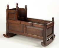 Lot 1373 - An 18th Century oak panelled cradle, the...