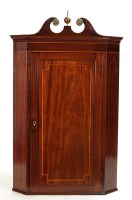 Lot 1396 - A Georgian mahogany corner cupboard with swan...