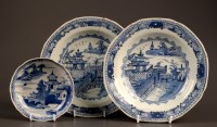 Lot 399 - † Two blue and white soup plates, painted with...