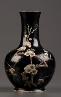 Lot 411 - A black ground bottle vase, moulded with the ''...