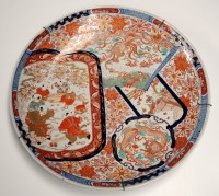 Lot 449 - A large Imari charger, painted with panels...