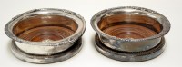 Lot 718 - † A pair of electroplated wine coasters, the...