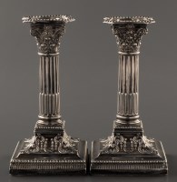 Lot 830 - A pair of George V candlesticks, by James...