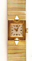 Lot 999 - Longines: a 9ct. gold lady's bracelet watch,...