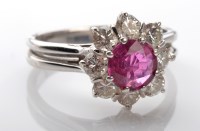 Lot 1033 - A ruby and diamond cluster ring, the circular...