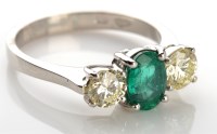 Lot 1044 - An emerald and diamond ring, the oval mixed...