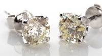 Lot 1049 - A pair of diamond ear studs, the brilliant cut...