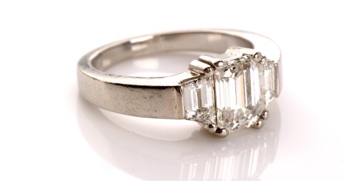 Lot 1054 - A diamond ring, the emerald cut diamond...