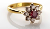 Lot 1056 - A ruby and diamond cluster ring, the circular...