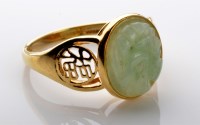 Lot 1062 - A jadeite and gold ring, the oval jadeite...