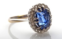 Lot 1070 - A sapphire and diamond cluster ring, the oval...