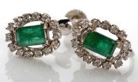 Lot 1101 - A pair of emerald and diamond earrings, each...