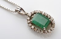 Lot 1103 - An emerald and diamond pendant, the step cut...