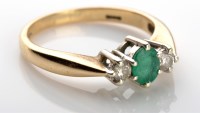Lot 1109 - An emerald and diamond ring, the oval mixed...