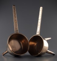 Lot 1238 - Two bronze skillets, each raised on three...