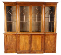 Lot 1329 - A Georgian mahogany breakfront bookcase with...