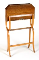 Lot 1372 - † A folding campaign writing desk with oval...