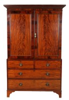 Lot 1393 - † A late Georgian mahogany linen press with a...