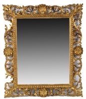 Lot 1434 - An ornate gilt Florentine frame wall mirror...