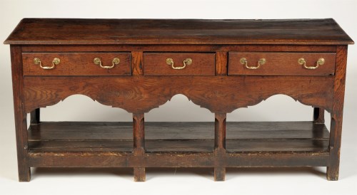 Lot 1442 - An early Georgian low oak dresser, fitted...