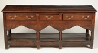 Lot 1442 - An early Georgian low oak dresser, fitted...