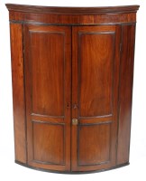 Lot 1465 - A late Georgian mahogany bowfront hanging...