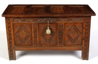 Lot 1468 - An 18th Century oak coffer with panelled lid...