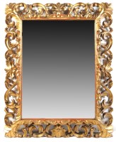 Lot 1469 - A large bevelled wall mirror in ornate...