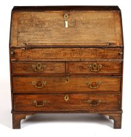 Lot 1473 - An early 18th Century oak bureau with hinged...