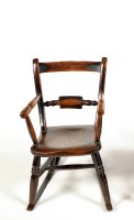 Lot 1494 - An early 19th Century child's elm seat rocking...