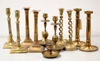 Lot 1550 - A pair of brass candlesticks on square bases,...