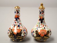 Lot 1554 - A pair of red mark Crown Derby bottle vases,...