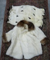 Lot 1709 - A child's ermine fur coat with rabbit fur...