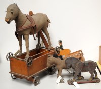 Lot 1717 - Three child's trolley horses; a toy stained...