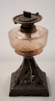 Lot 1738 - An oil lamp with rose tinted glass reservoir...