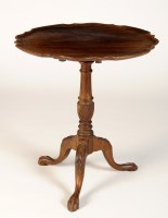 Lot 1828 - A circular mahogany tip-up-top occasional...