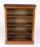 Lot 1844 - A walnut four-tier open bookcase, raised on a...