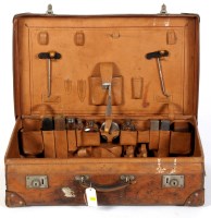 Lot 1956 - A leather suitcase, the lid engraved initials '...